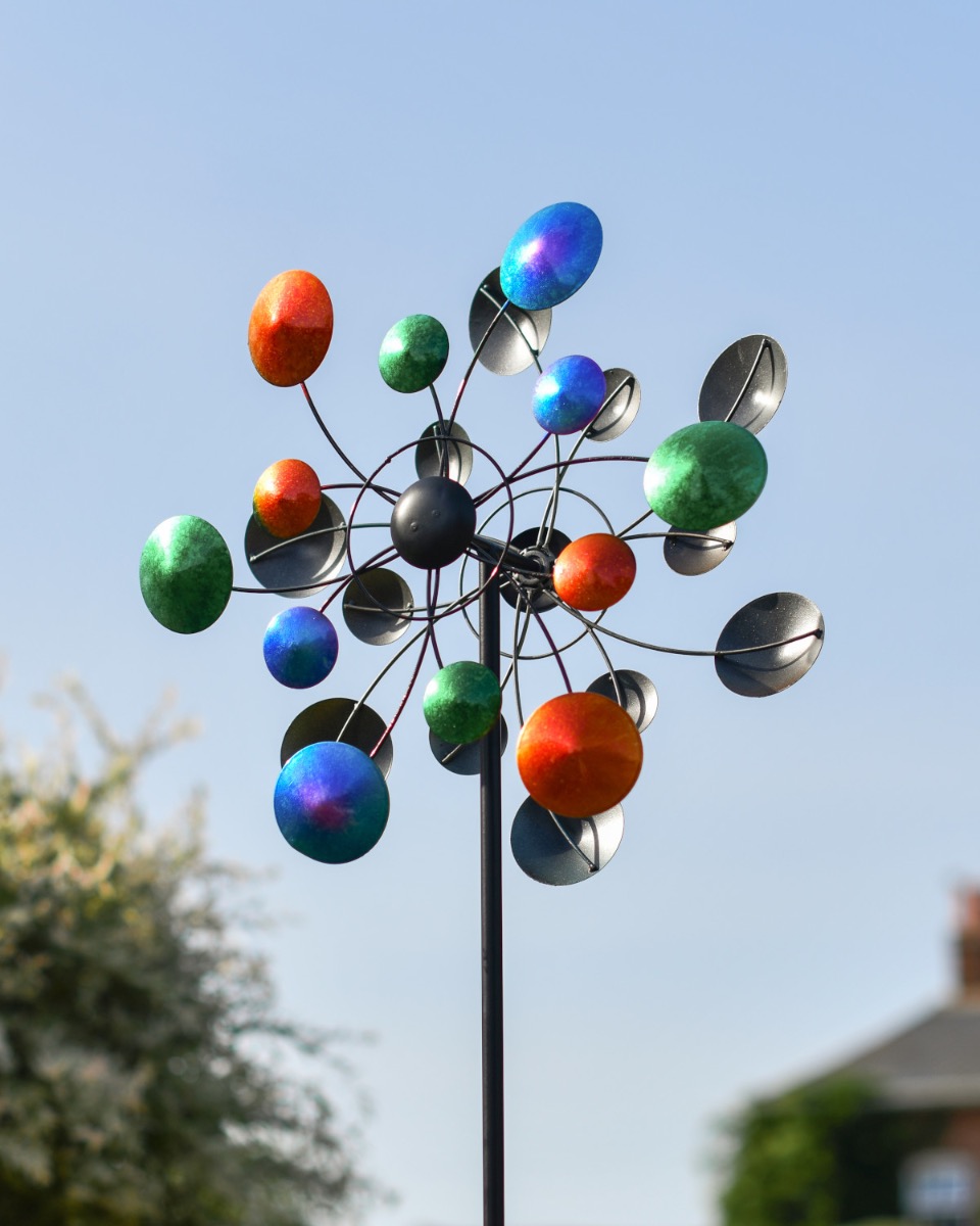 Steel "Celestial Orbit" Wind Spinner in a Blue Sky Setting