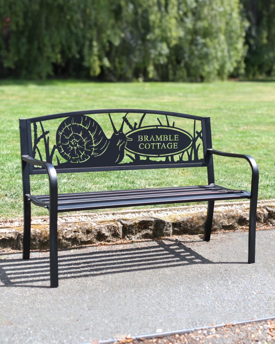 "Slow & Steady" Snail Black Two Seater Park Bench in a Garden